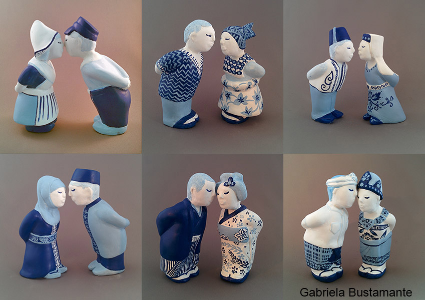 Figuren in Delfts blauw met verschillende etnische achtergronden geven elkaar een kus